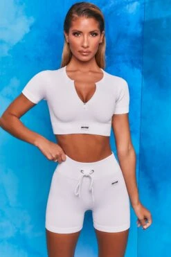Perform Ribbed Short Sleeve Zip Front Crop Top In White 10 Perform Ribbed Short Sleeve Zip Front Crop Top In White -Core Fit Shop bt0102 bt0104 3 perform results white ribbed zip short sleeve crop tshirt crop top shorts drawstring two piece set