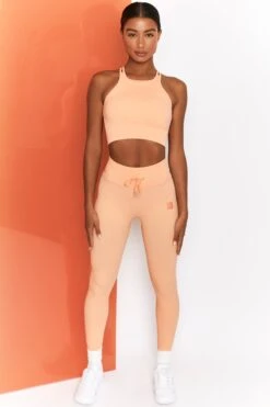 Feel Your Power Ribbed Racer Crop Top In Peach -Core Fit Shop bt0302 bt0304 1 energise peach ribbed drawstring workout joggers feel your power ribbed workout top 3