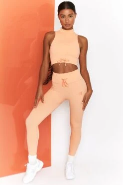 Miles Ahead Ribbed High Neck Crop Top In Peach -Core Fit Shop bt0305 bt0302 1 energise peach ribbed drawstring workout joggers mile ahead ribbed work out crop top 2