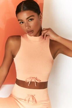 Miles Ahead Ribbed High Neck Crop Top In Peach -Core Fit Shop bt0305 bt0302 8 energise peach ribbed drawstring workout joggers mile ahead ribbed work out crop top 2