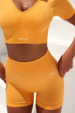 Gradient Scoop Neck Ruched Crop Top In Light Orange 11 Gradient Scoop Neck Ruched Crop Top In Light Orange -Core Fit Shop bt0361 bt0366 5 gradient flash light orange scrunched front short sleeve crop top high waist shorts sportswear set 4