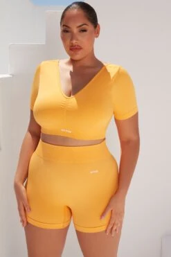 Gradient Scoop Neck Ruched Crop Top In Light Orange 13 Gradient Scoop Neck Ruched Crop Top In Light Orange -Core Fit Shop bt0361 bt0366 8 gradient flash light orange scrunched front short sleeve crop top high waist shorts sportswear set 4