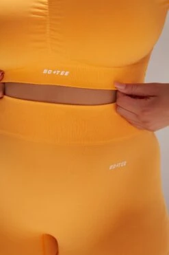 Gradient Scoop Neck Ruched Crop Top In Light Orange 12 Gradient Scoop Neck Ruched Crop Top In Light Orange -Core Fit Shop bt0361 bt0366 9 gradient flash light orange scrunched front short sleeve crop top high waist shorts sportswear set 1 1