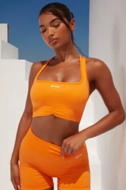 Radiate Ruched Sports Bra In Orange 24 Radiate Ruched Sports Bra In Orange -Core Fit Shop bt0363 bt0366 3 orange ribbed detail crop top high waisted shorts 1