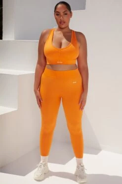 Surge Curved Waist Seamless Leggings In Orange -Core Fit Shop bt0364 bt0365 10 surge orange leggings beam light crop top 1