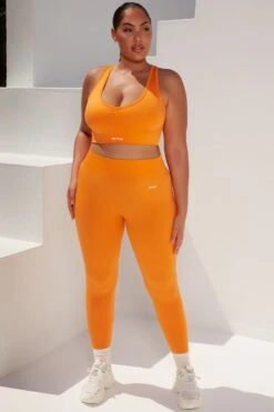 Surge Curved Waist Seamless Leggings In Orange -Core Fit Shop bt0364 bt0365 11 surge orange leggings beam light crop top 1
