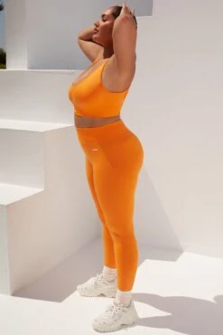 Surge Curved Waist Seamless Leggings In Orange -Core Fit Shop bt0364 bt0365 17 surge orange leggings beam light crop top 1