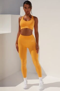 Surge Curved Waist Seamless Leggings In Light Orange 19 Surge Curved Waist Seamless Leggings In Light Orange -Core Fit Shop bt0364 bt0365 1 surge light orange leggings beam light crop top 2