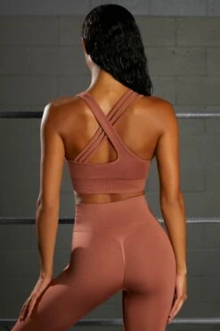 Emerge Cross Strap Seamless Plunge Sports Bra In Rust -Core Fit Shop bt0371 6 emerge rust strap detail plunge sports bra